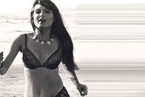 Parveen Babi running out of the water in a bikini